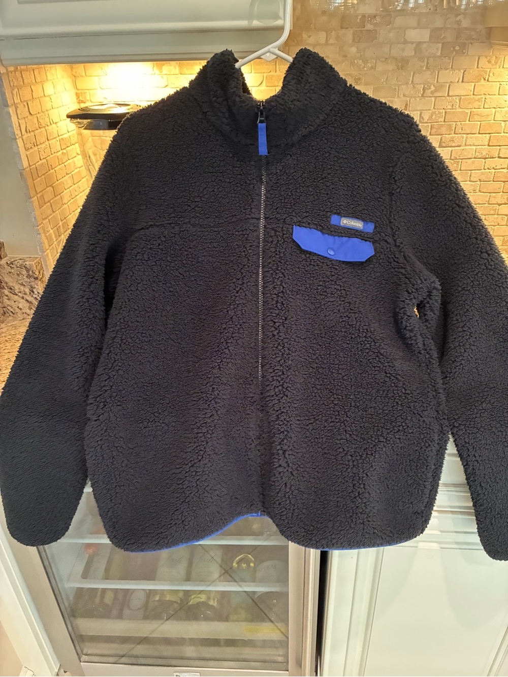 Columbia woman’s Black Sherpa Fleece Jacket with Royal Blue Trim and lining.